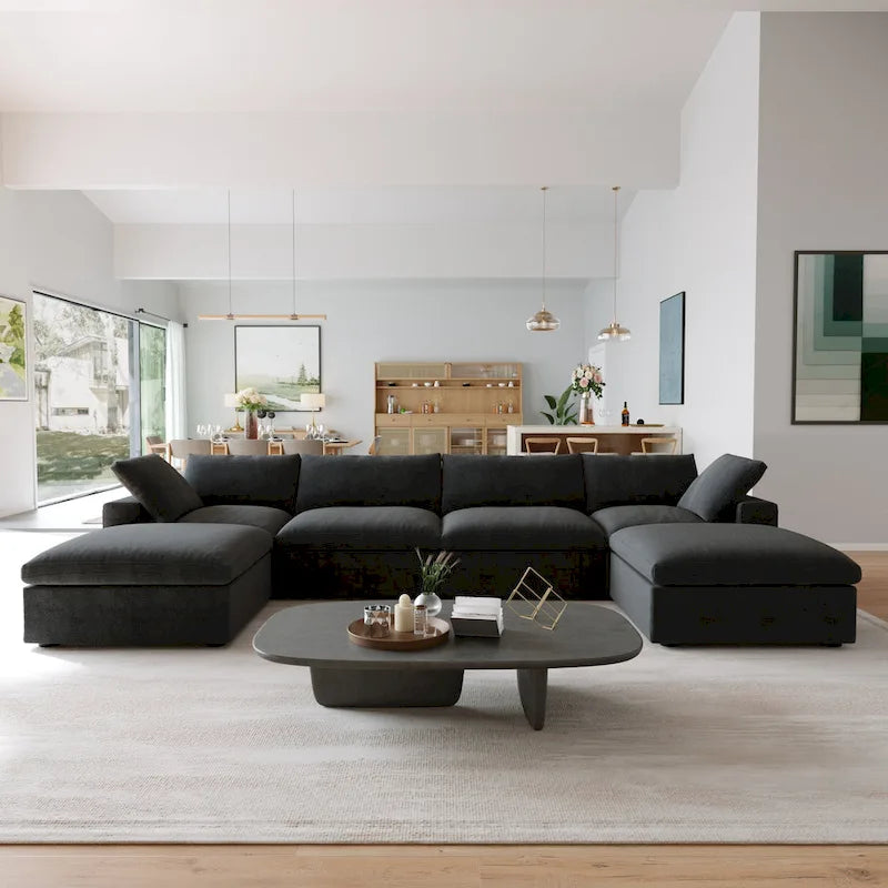 Canapé d'angle surdimensionné en duvet noir avec pouf