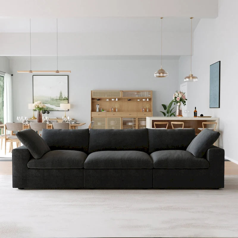 Canapé d'angle surdimensionné en duvet noir avec pouf